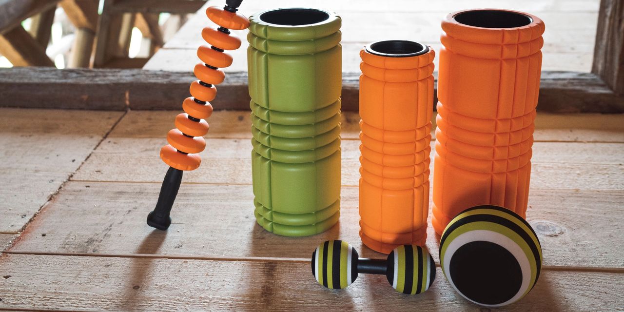 Various types of foam rollers, including a bar, dumbbells, and ball