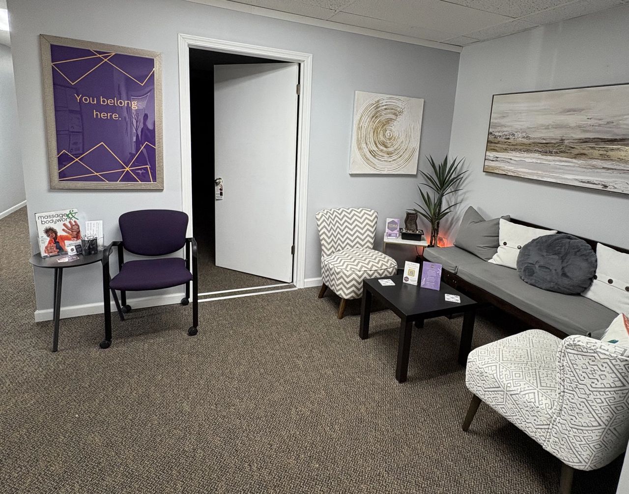 The entryway of KCHA where the "You Belong Here" sign is prominently hanging on the wall. 