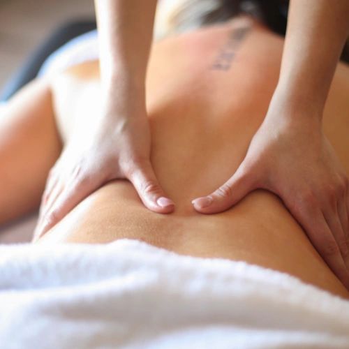 Massage therapist working on a client's lower back
