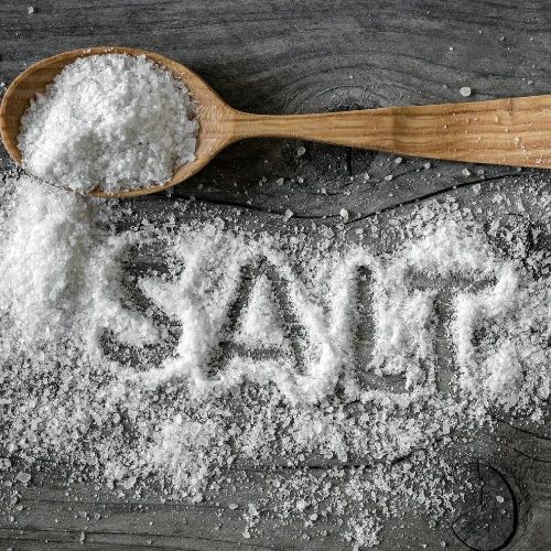 Salt spilling off a spoon 