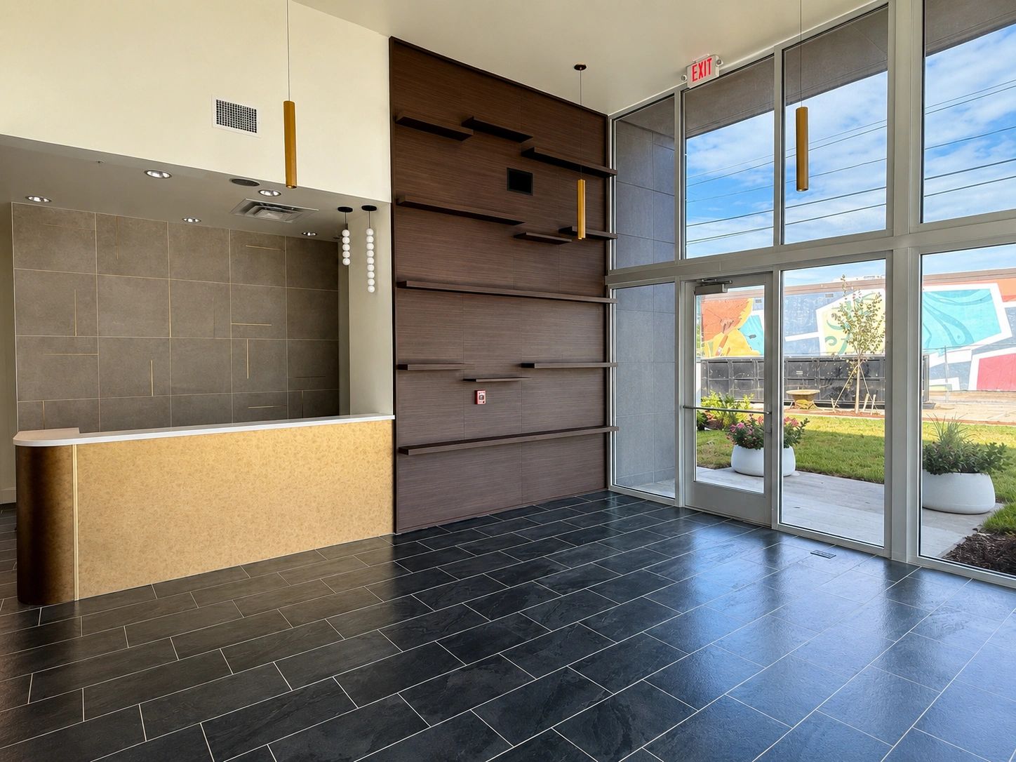 Modern lobby with reception desk and large windows.