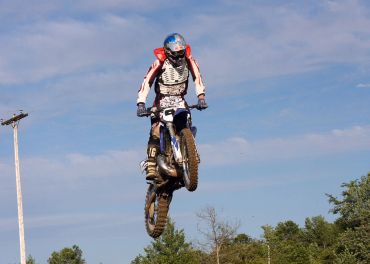 Motocross rider in mid-air jump.