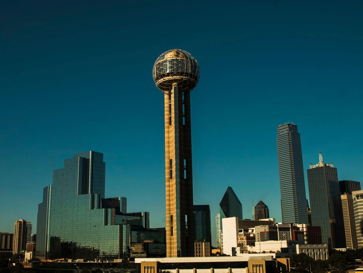 Dallas skyline featuring the iconic Reunion Tower under a clear blue sky.