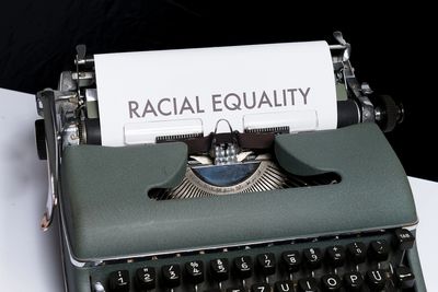 Type writer with paper that reads, "Racial Equality."