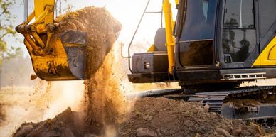 Excavator dumping soil during a construction project.