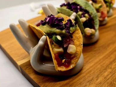 Mini Indian fusion tacos with masala chicken and avocado crema served at a event in Dublin, CA

