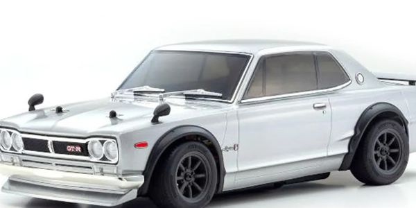 Silver classic Nissan GT-R car with black rims and fender flares.