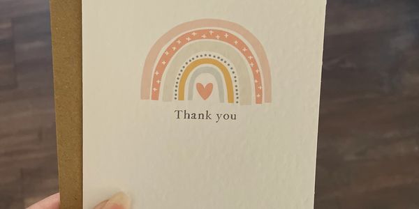 Thank you card - hand-drawn rainbow with pink pastel colours. With message 'thank you' typewriter fo