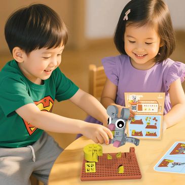 Two children happily playing with an interactive elephant toy and activity book.