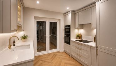 Modern kitchen with elegant lighting and cabinetry.