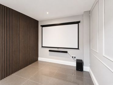 Minimalist home theater setup with projector screen.