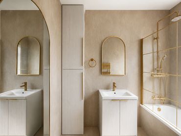 Modern bathroom with gold fixtures and beige tones.