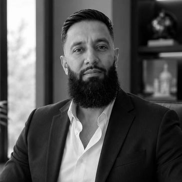 Portrait of a confident man with a beard in business attire.