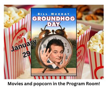 boxes of popcorn behind movie poster. event information