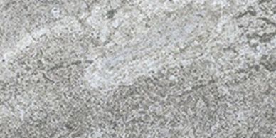 Texture grise rugueuse d'une surface granuleuse.