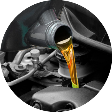 Golden engine oil pouring into a car engine, highlighting vehicle maintenance.