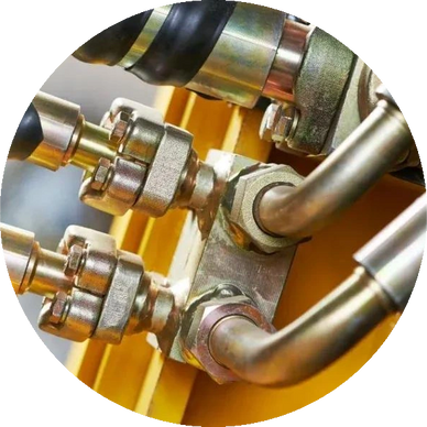 Close-up of metal hydraulic pipes and connectors on machinery.
