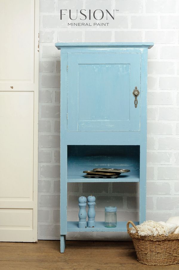 Vintage blue cabinet with distressed finish and kitchen accessories.