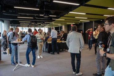 People mingling at a networking event indoors.