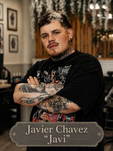 Portrait of Javier Chavez with tattoos and arms crossed.