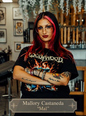 Portrait of Mallory Castaneda with vibrant hair and tattoos.