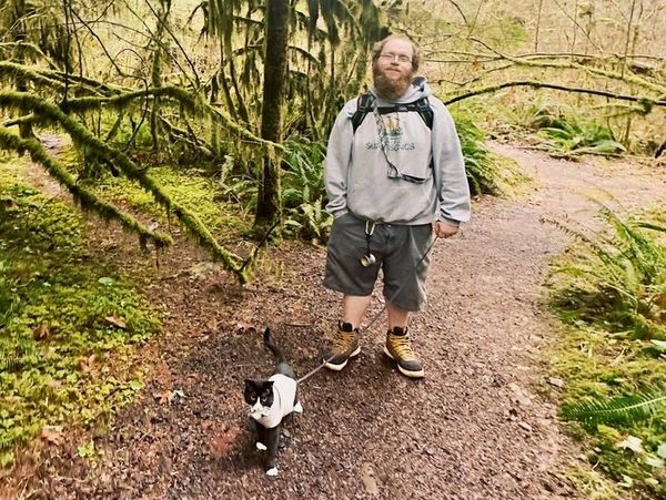 Cat trainer outside training a cat.