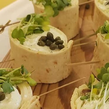 Smoked salmon loc pinwheels, lemon creme fraiche, capers, raddish sprouts