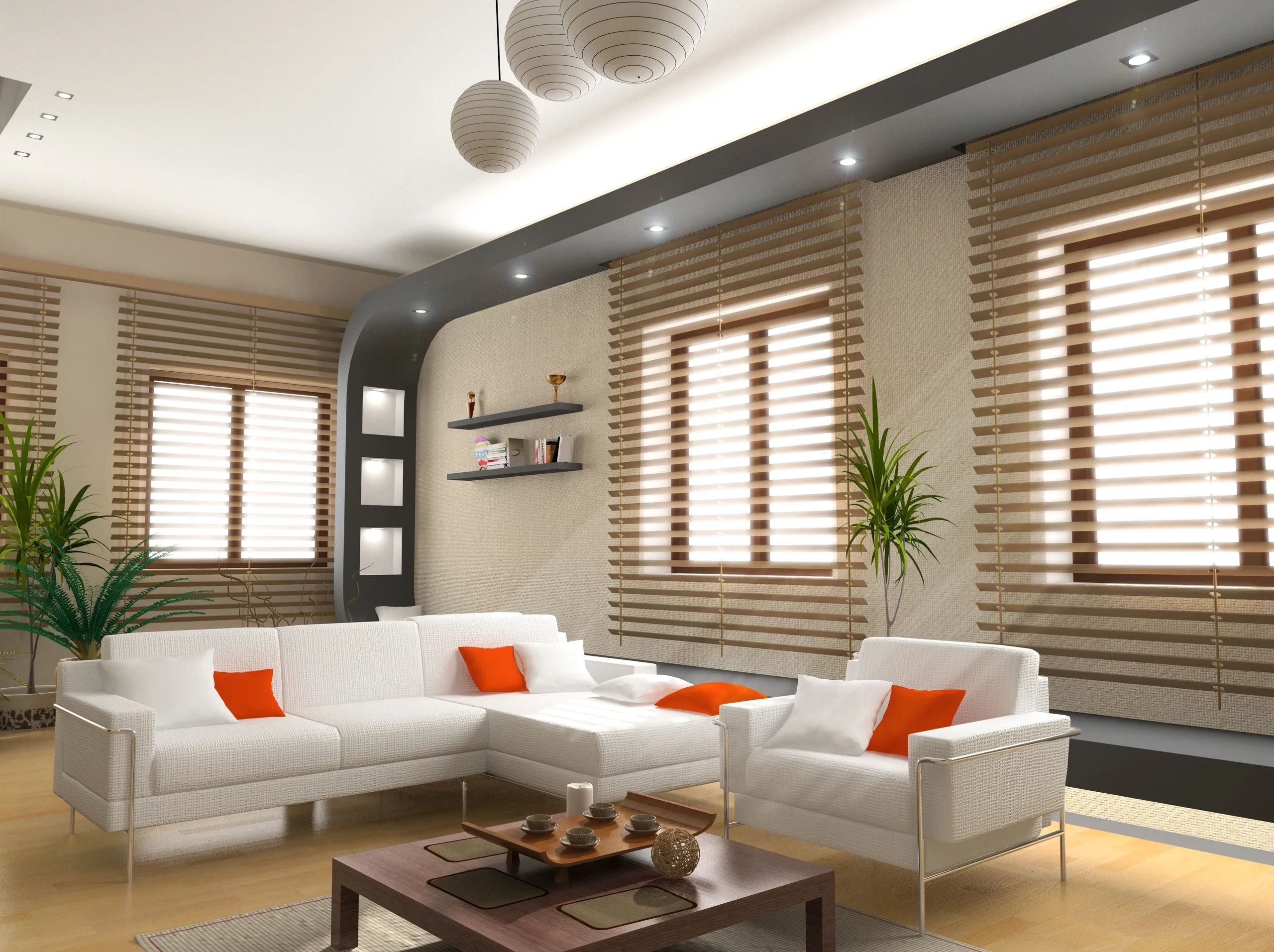 Modern living room with white furniture, orange cushions, and natural light from large windows.