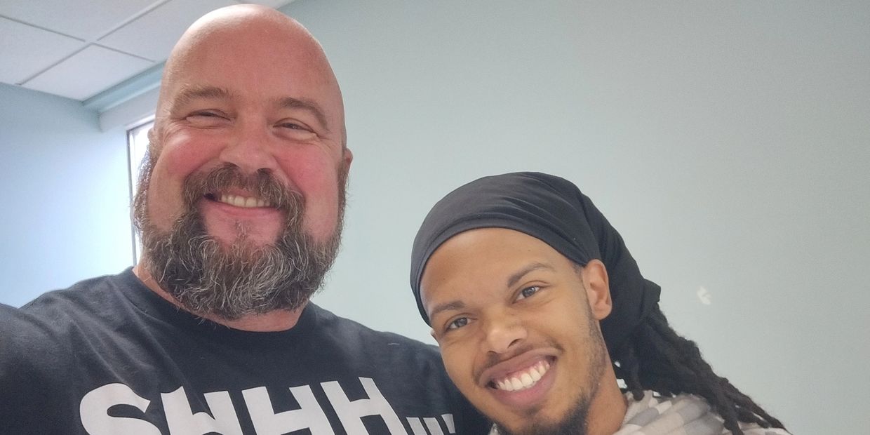 Two Men Smiling and Posing for Photograph