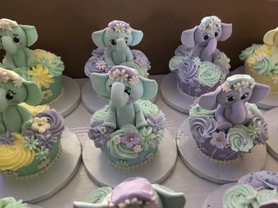 Mini cakes with custom elephant toppers in pastel colors 
imagiCakes Philadelphia