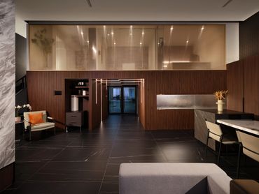 Modern office lobby with warm wood paneling and stylish seating.