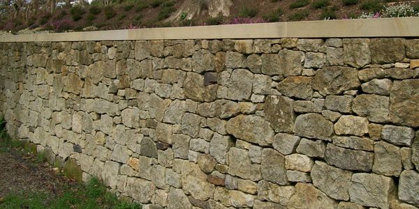 Retaining dry stonewall built with Sussex sandstone.