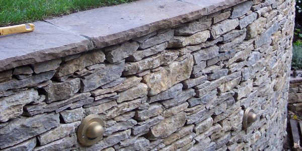 Retaining drystone wall built with Purbeck stone
