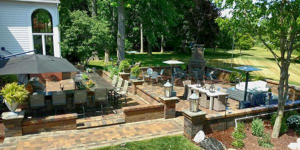 Custom Outdoor living space in Shelby Township, MI. Brick Pavers, Outdoor fireplace, outdoor kitchen