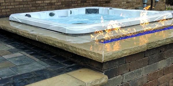 Brick paver patio with a built in spa & fire feature
