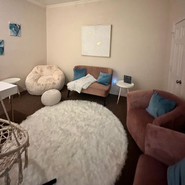 Cozy living room with plush seating and a round white rug.