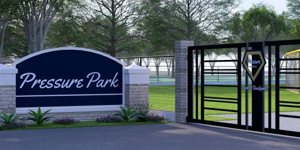 Entrance gate and sign for Pressure Park with greenery and trees.