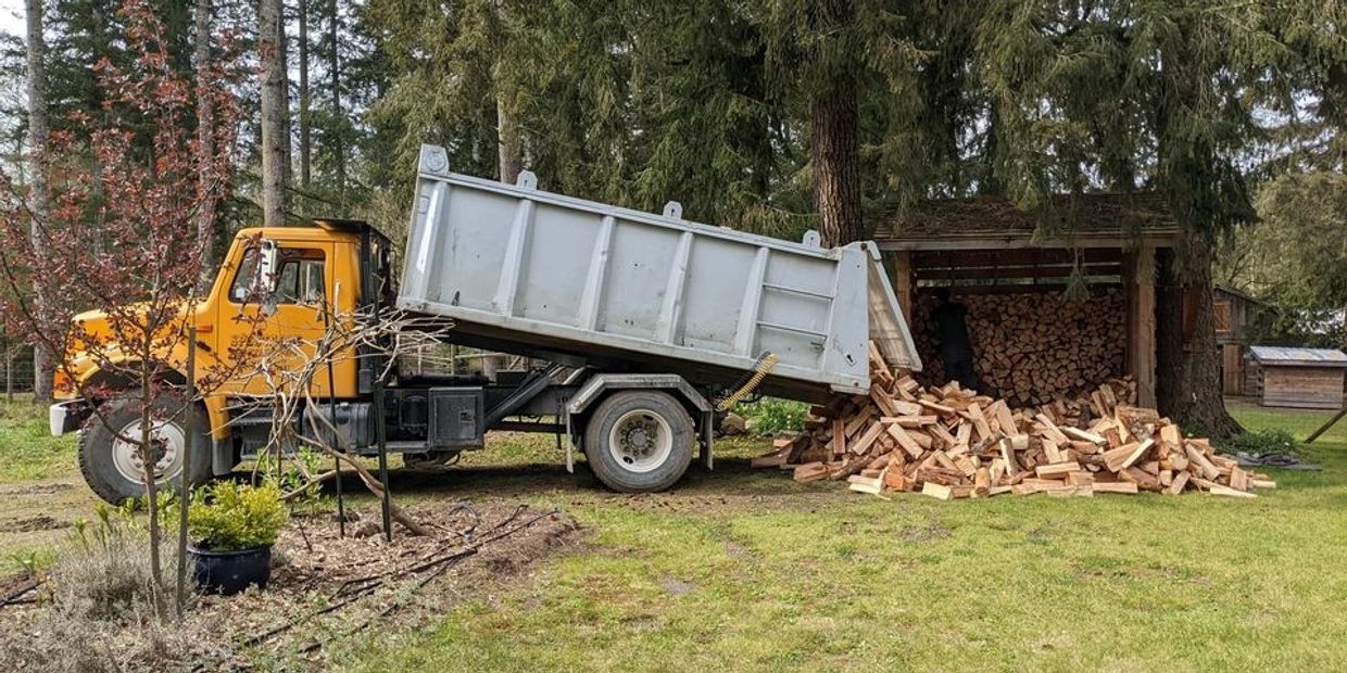 Coastal Firewood dump truck delivering a large load of firewood