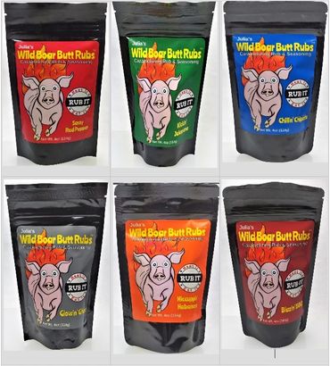 Six colorful packages of Julia's Wild Boar Butt Rubs seasoning blends.