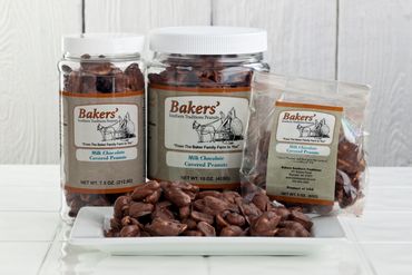 Various containers of Bakers' milk chocolate-covered peanuts arranged on a white plate.