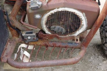 Rusty machinery with a rat inside a protective cage.