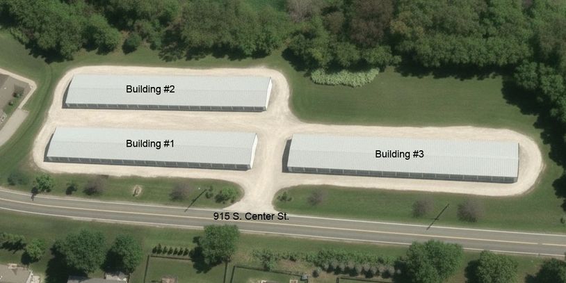 Aerial view of three labeled storage buildings surrounded by greenery.