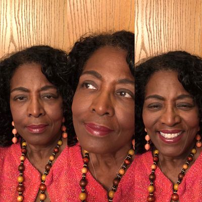 A woman in vibrant attire shows three different facial expressions against a wooden background.