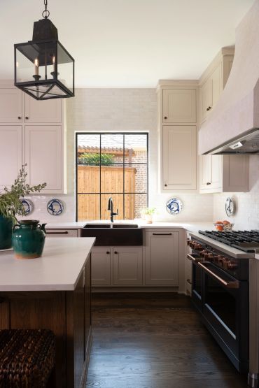 Bright kitchen with white cabinets and black accents.