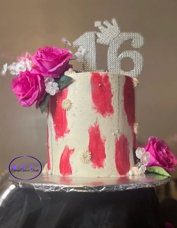 Elegant 16th birthday cake with pink flowers and red accents.