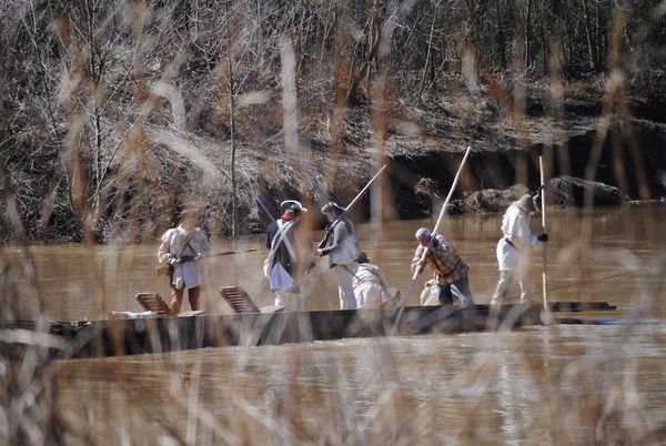 People walking and wearing period war costumes