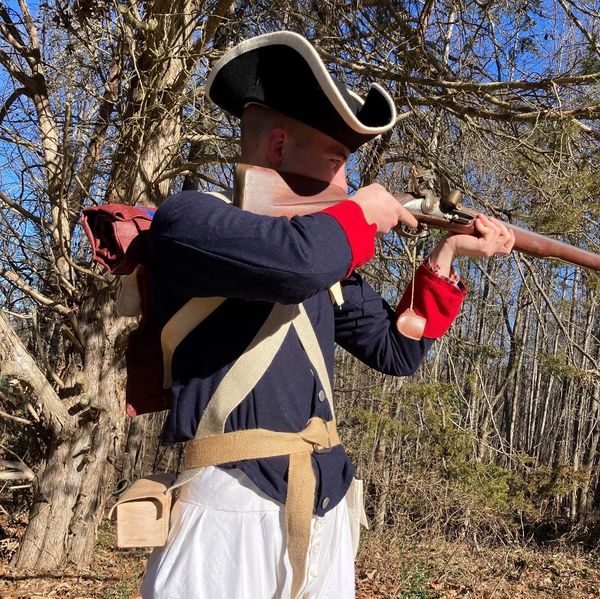 A person wearing ancient US navy war uniform 