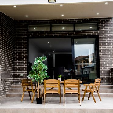 Outdoor entertainment area with landscaped gardens and modern seating