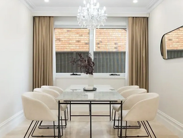 Modern dining area with pendant lighting and timber accents