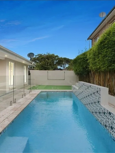 Luxury backyard pool area with integrated landscaping design